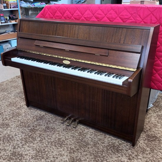 Kemble Cambridge 10 upright piano in a  satin mahogany finish.