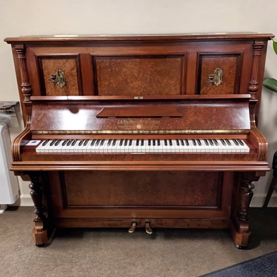 Pfeiffer model 135 upright piano in a satin walnut casework.