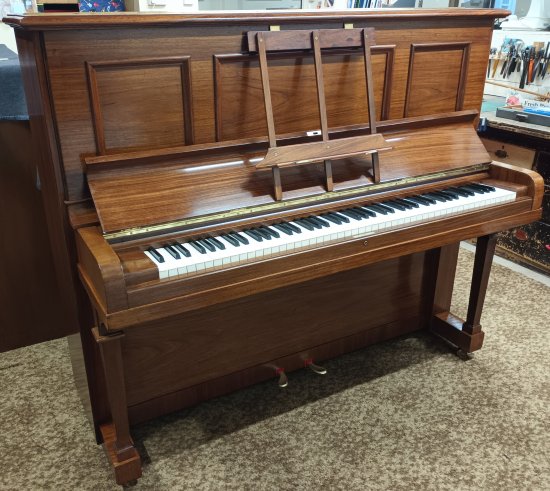 Steinway 'Vertegrand' upright piano in a polished rosewood finish.