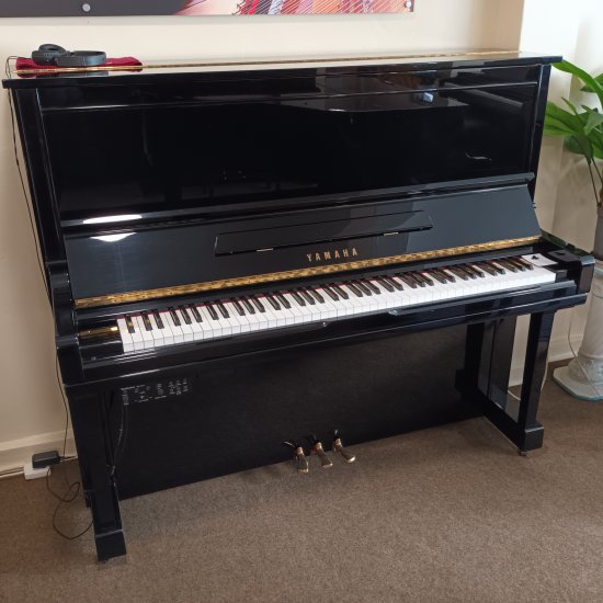 Yamaha U300 upright piano in a Black Polyester casework.